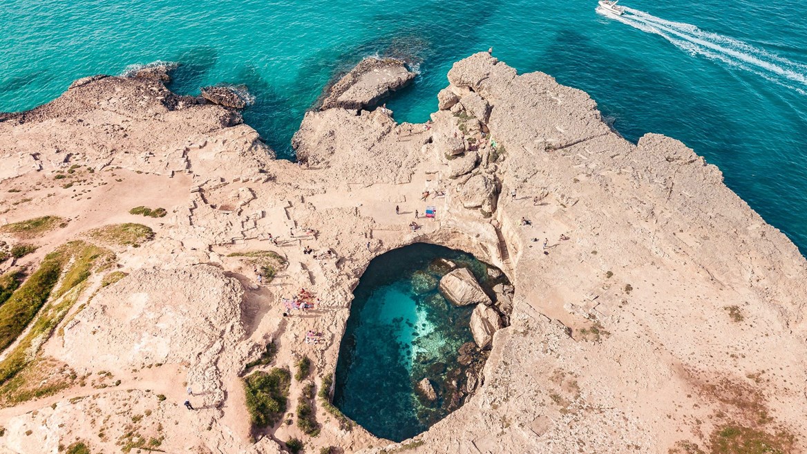 En el sitio arqueológido de Roca Vecchia hay lugares tan espectaculares como la Grotta della Poesía, una piscina natural de aguas turquesas excavada en una roca.