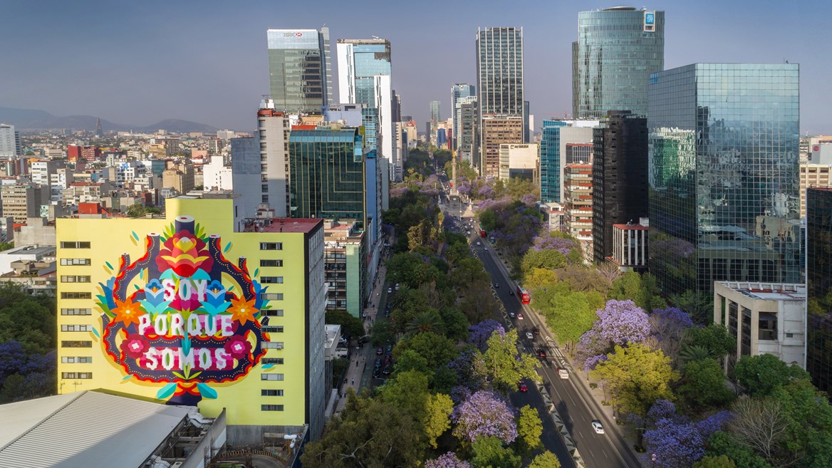The work by Boa Mistura on one of the buildings on the Paseo de la Reforma in Mexico City that says Soy porque somos (“I am because we are”).