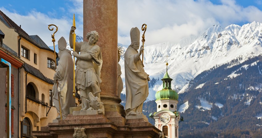 Travel to Innsbruck for 15 000 Avios. In the picture, a view of the snow-capped mountains from the historic centre of Innsbruck.