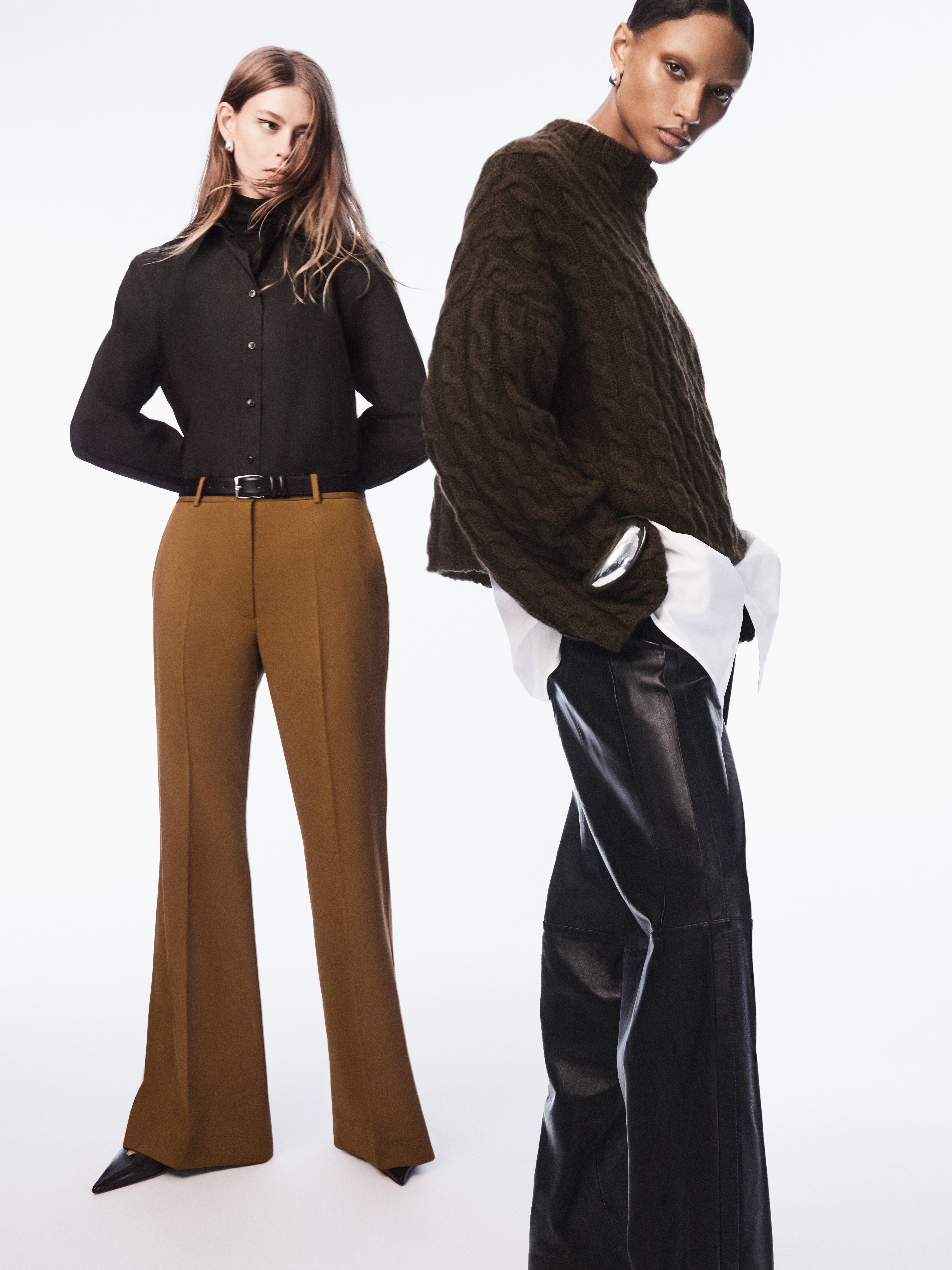 Get up to 10 Avios for every £1 you spend at Cos. In the picture, two models pose with the Cos winter collection.