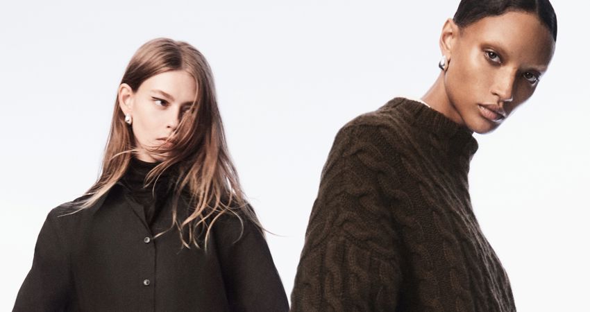 Get up to 10 Avios for every £1 you spend at Cos. In the picture, two models pose with the Cos winter collection.