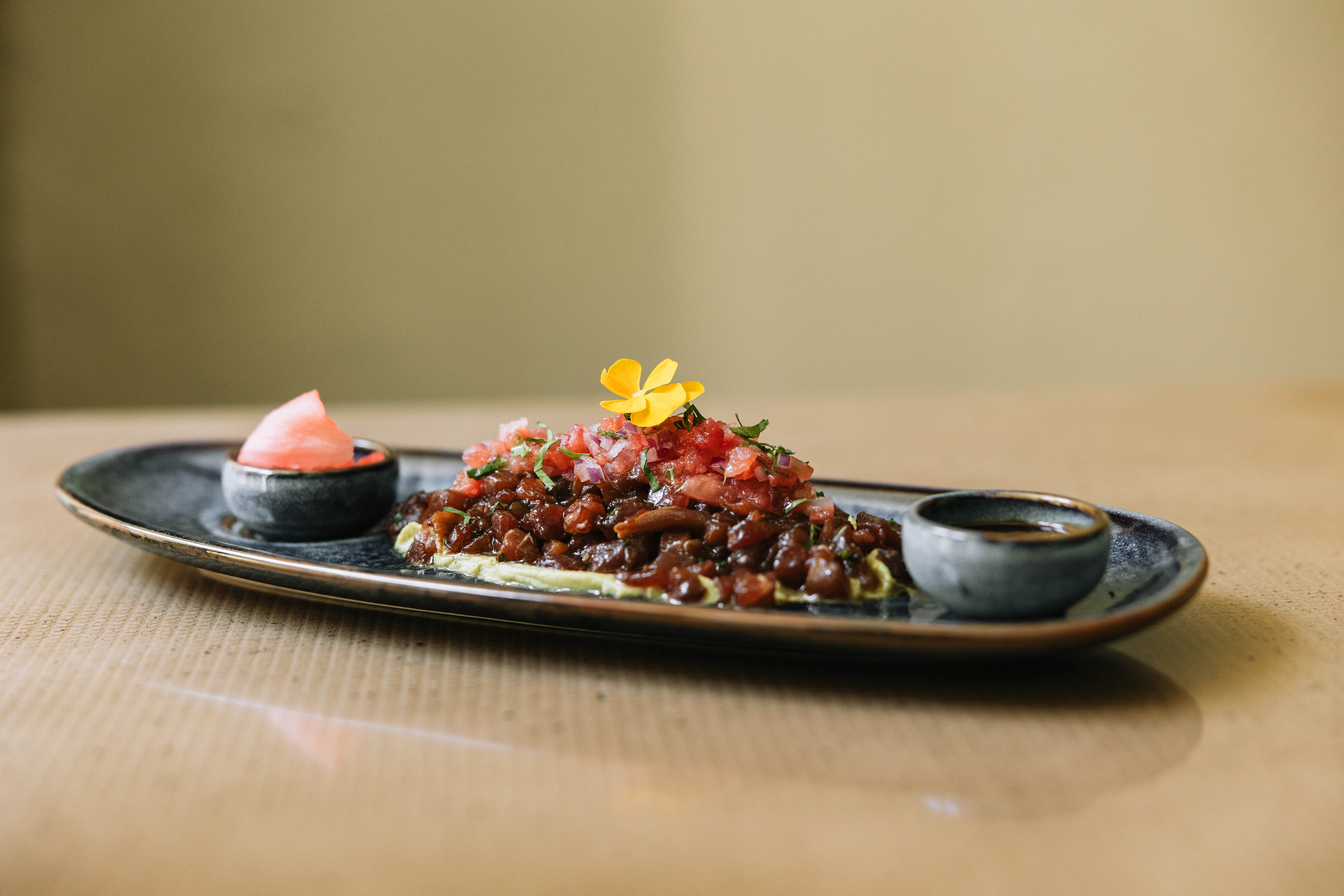Uno de los espectaculares platos de de Evranto, un tartar de atún con pico de gallo, presentado junto a sus salsas.