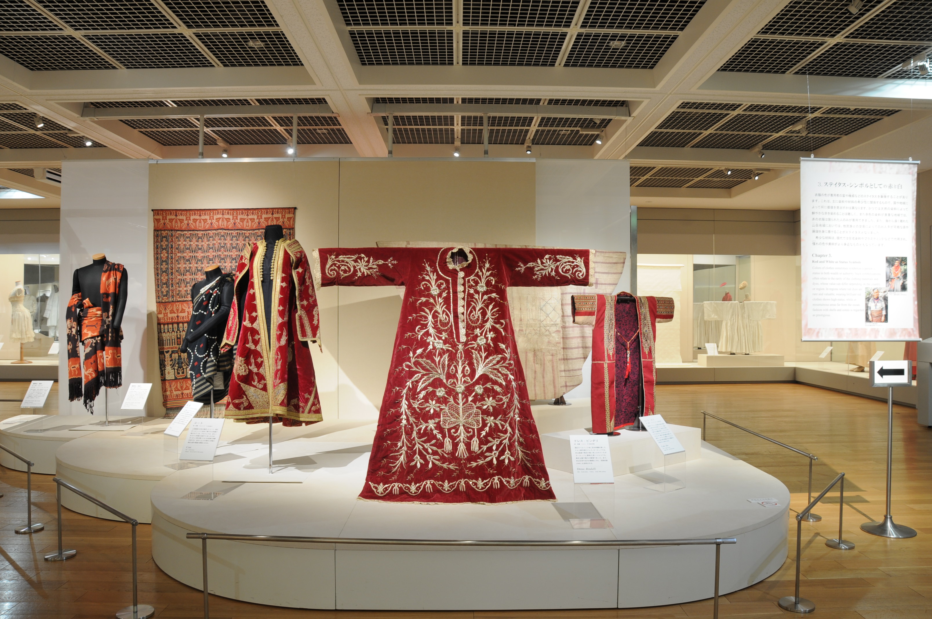 In the picture, traditional tunics of Imperial Japan, those closest to the camera richly embroidered in gold on red velvet