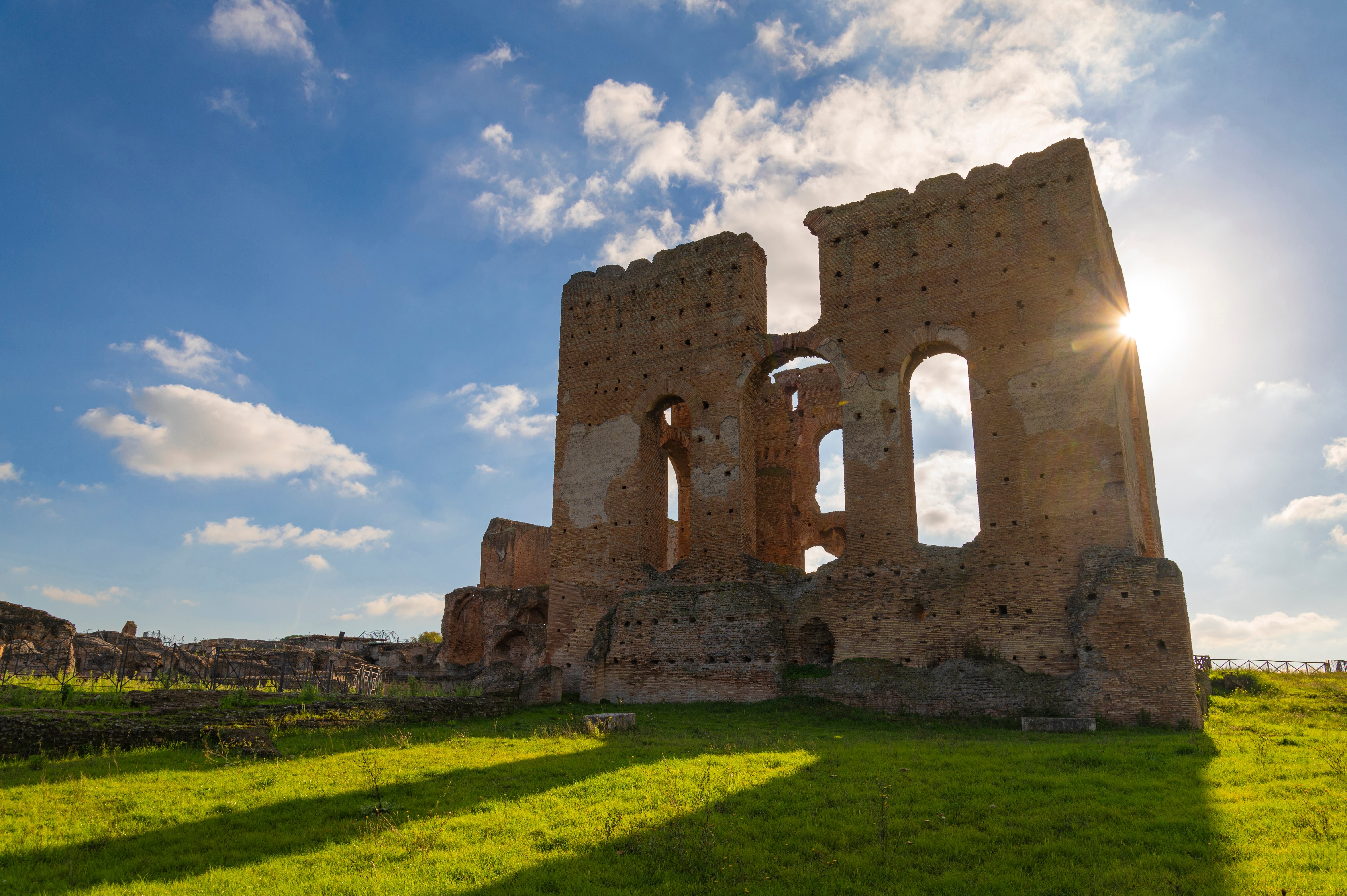 One of the monumental walls of the Villa dei Quintili, the evening sun shines through the windows