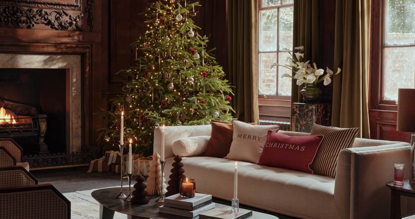 In the picture, a living room with a Christmas tree and decorations from H&M Home.