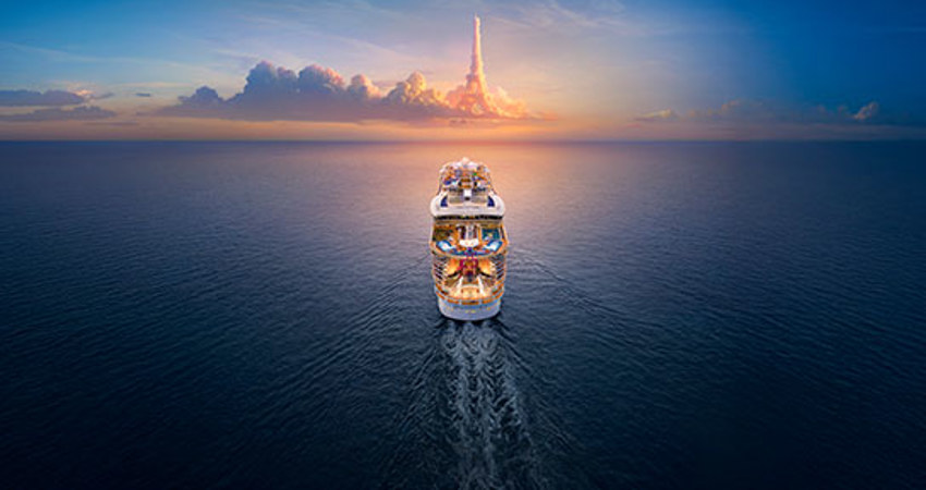 The image shows the rear of a Royal Caribbean cruise ship sailing across the sea. On the horizon, the clouds shape the Eiffel Tower.