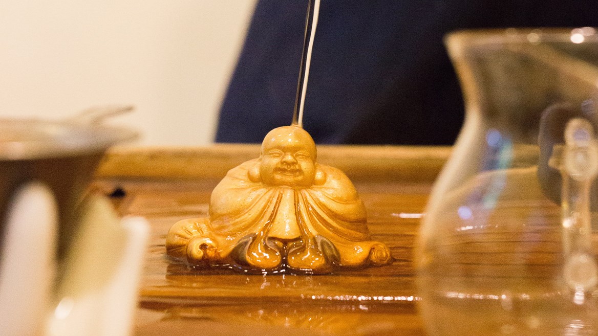 This statue of Buddha changes colour when hot liquid is poured on it.